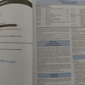 OSHA 29 CFR 1910 General Industry Regulations book open to hazardous materials and compressed gases sections.